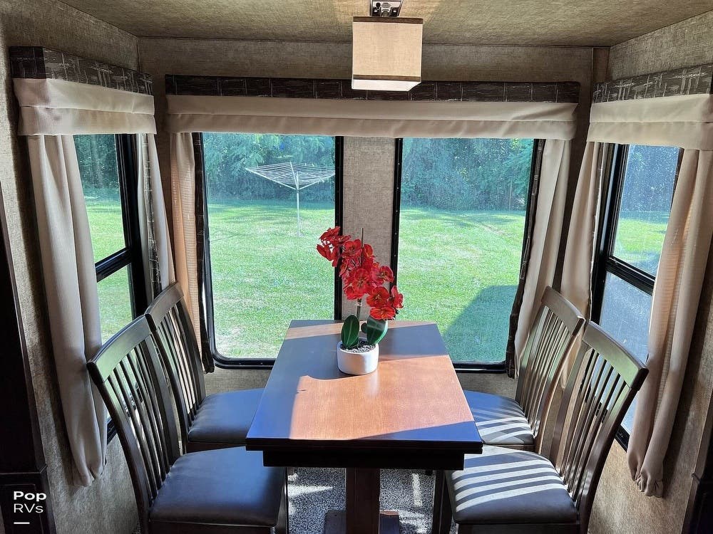 Dining area with large windows.
